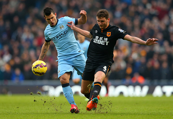 MANCHESTER, ENGLAND - FEBRUARY 07: Sergio Aguero of Manchester City competes with Alex Bruce of Hull City during the Barclays Premier League match between Manchester City and Hull City at the Etihad Stadium on February 7, 2015 in Manchester, England.