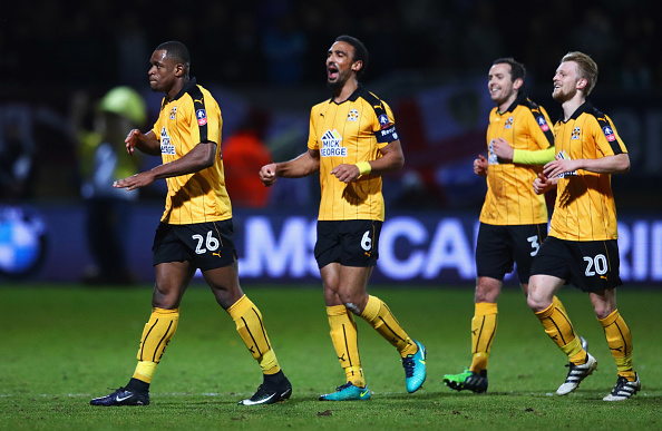 CAMBRIDGE, ENGLAND - JANUARY 09: Uche Ikpeazu of Cambridge United (26) celebrates with team mates as he scores their first goal during the Emirates FA Cup Third Round match between Cambridge United and Leeds United at Cambs Glass Stadium on January 9, 2017 in Cambridge, England.