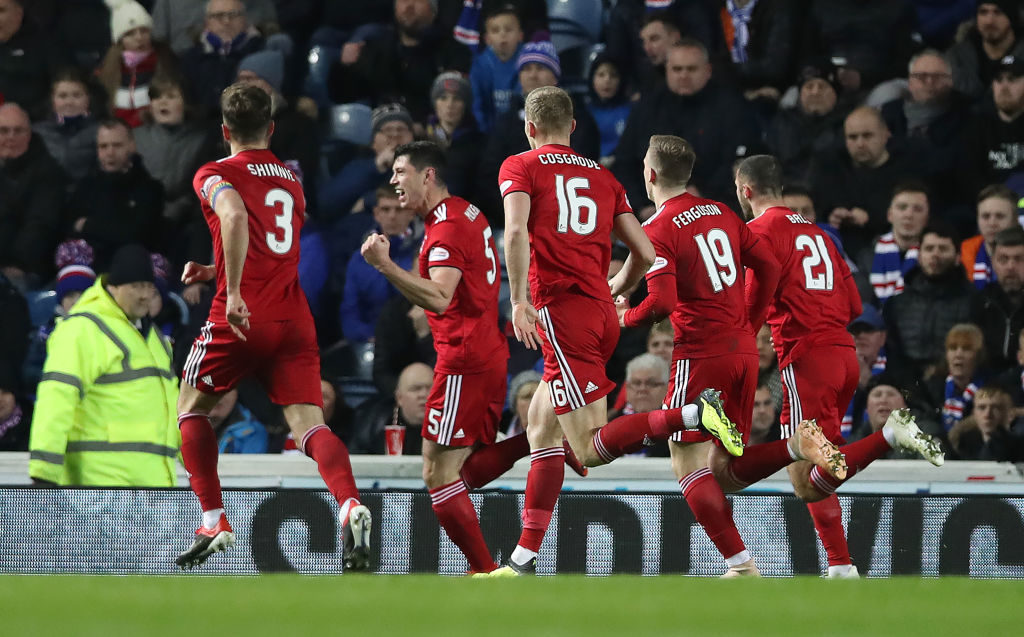 GLASGOW, SCOTLAND - DECEMBER 05: Scott McKenna of Aberdeen celebrates after he scores the opening goal during the Scottish Ladbrokes Premiership match between Rangers and Aberdeen at Ibrox Stadium on December 5, 2018 in Glasgow, Scotland. 
