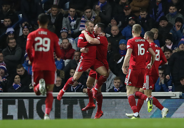 GLASGOW, SCOTLAND - DECEMBER 05: Scott McKenna of Aberdeen celebrates after he scores the opening goal during the Scottish Ladbrokes Premiership match between Rangers and Aberdeen at Ibrox Stadium on December 5, 2018 in Glasgow, Scotland. 