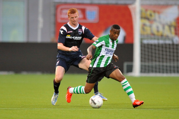 (L-R) Scott Boyd of Ross County FC, Giovanni Hiwat of PEC Zwolle during the pre-season friendly match between PEC Zwolle and Ross County on July 26, 2013 in Zwolle, The Netherlands.