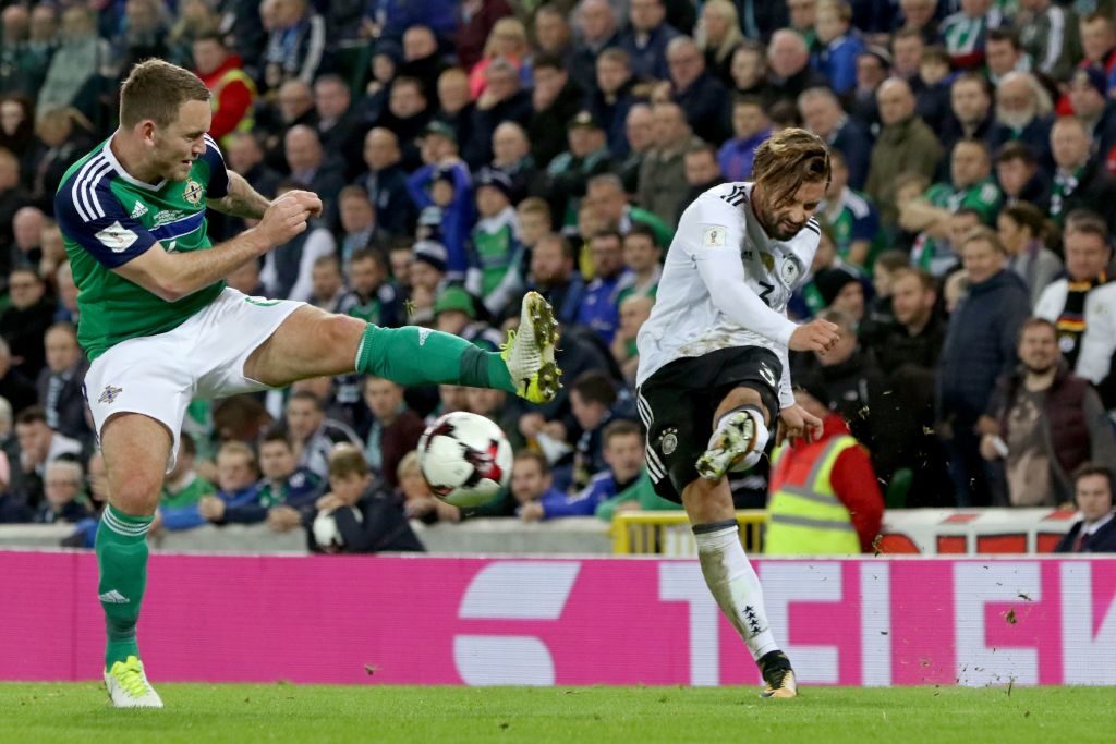 Northern Ireland's defender Lee Hodson (L) attempts to block a cross from Germany's defender Marvin Plattenhardt during the FIFA World Cup 2018 qualification football match between Northern Ireland and Germany at the National Football Stadium at Windsor Park in Belfast on October 5, 2017. / AFP PHOTO / Paul FAITH