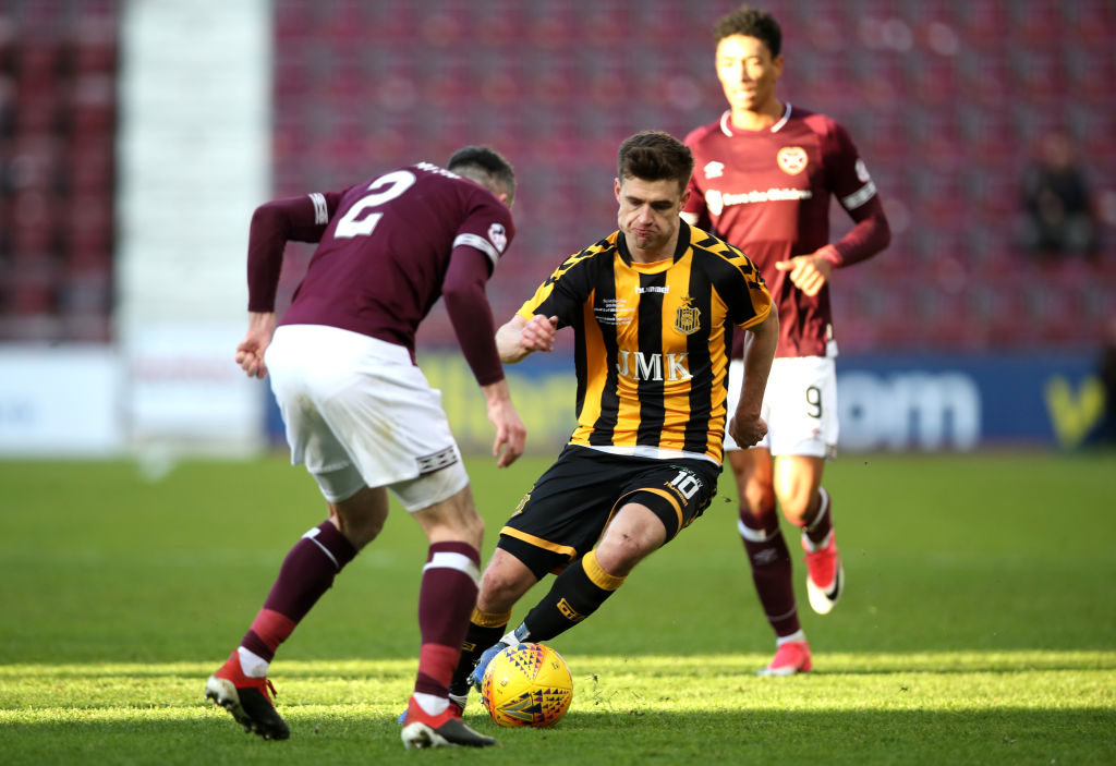 EDINBURGH, SCOTLAND - FEBRUARY 10: Jamie Glasgow of Auchinleck Talbot runs with the ball under pressure from Michael Smith of Hearts during the Scottish Cup 5th Round match between Heart of Midlothian and Auchinleck Talbot at Tynecastle Stadium on February 10, 2019 in Edinburgh, Scotland.