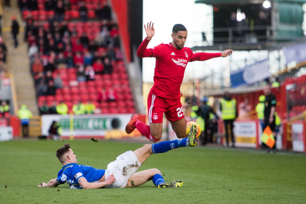 ABERDEEN, SCOTLAND - FEBRUARY 10: Barry Maguire of Queen of The South tackles Max Lowe of Aberdeen during the Scottish Cup 5th Round match between Aberdeen and Queen of The South at Pittodrie Stadium on February 10, 2019 in Aberdeen, Scotland.