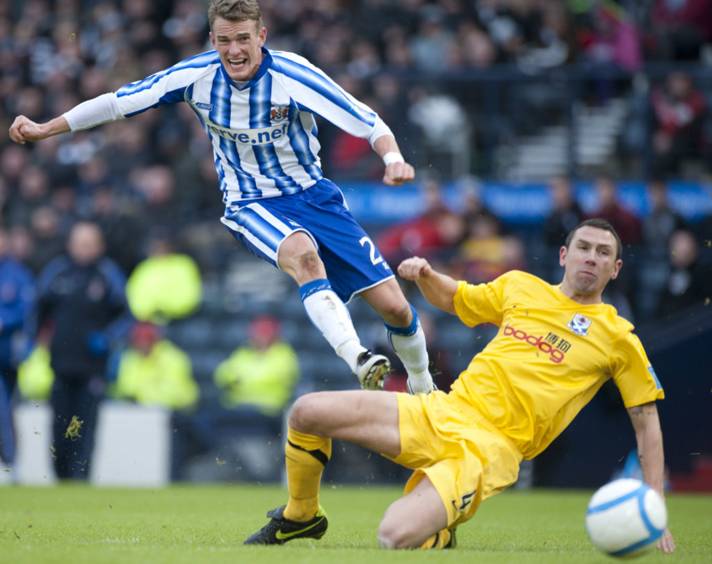 GLASGOW, SCOTLAND - JANUARY 28: Dean Shiels of Kilmarnock shoots as John Robertson of Ayr defends during the Scottish Communities Cup Semi Final match between Ayr United and Kilmarnock at Hampden Park on January 28, 2012 in Glasgow, United Kingdom.