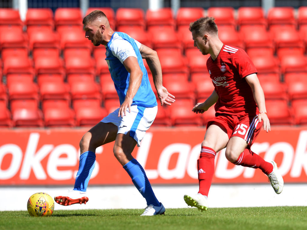 PERTH, SCOTLAND - JULY 08: Bruce Anderson of Aberdeen is held off by Liam Gordon of St Johnstone in the first half during the Pre-Season Friendly between St Johnstone and Aberdeen at McDiarmid Park on July 8, 2018 in Perth, Scotland.