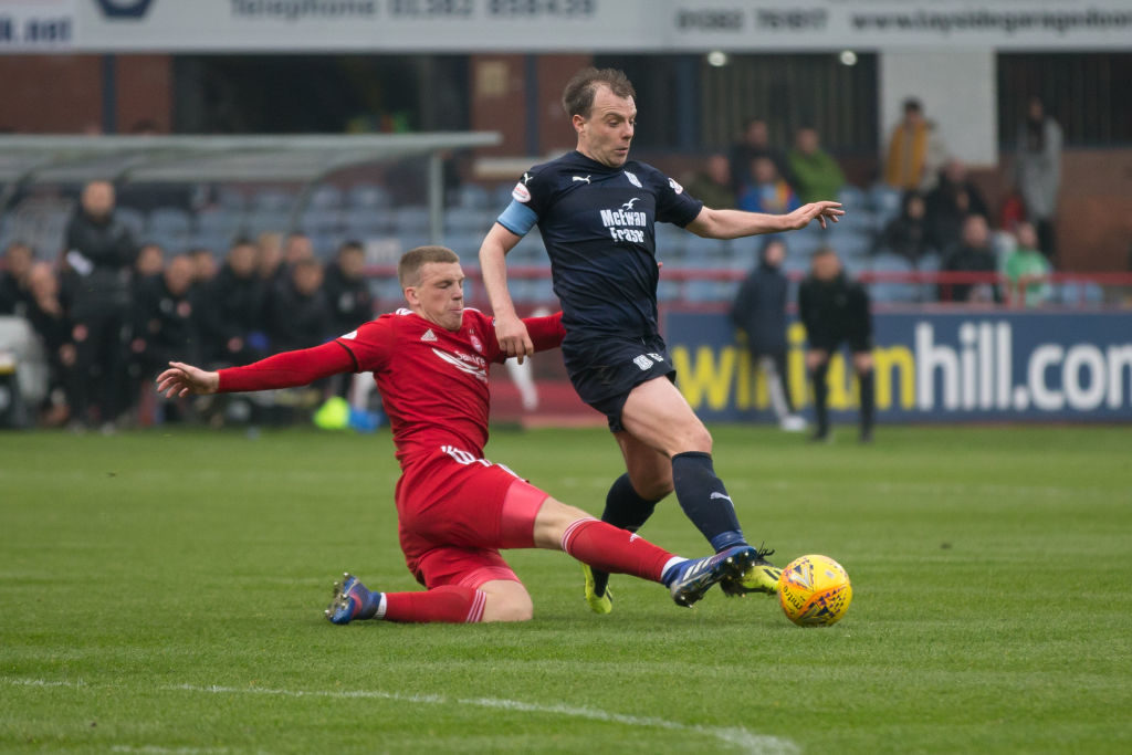 6th April 2019, Dens Park, Dundee, Scotland; Ladbrokes Premiership football, Dundee versus Aberdeen; Paul McGowan of Dundee is tackled by Lewis Ferguson of Aberdeen