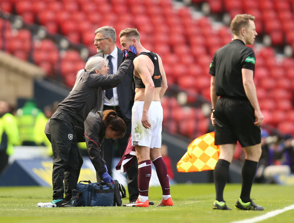 13th April 2019, Hampden Park, Glasgow, Scotland; Scottish Cup football, semi final, Heart of Midlothian versus Caledonian Thistle; Steven MacLean of Heart of Midlothian receives treatment and a shirt change for a nosebleed