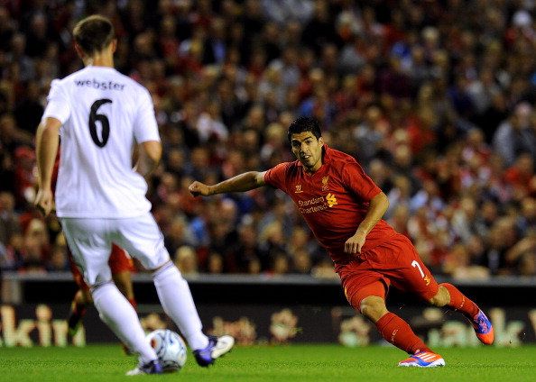 LIVERPOOL, ENGLAND - AUGUST 30: (THE SUN OUT, THE SUN ON SUNDAY OUT) Andy Webster of Hearts and Luis Suarez of Liverpool in action during the UEFA Europa League play-off round second leg match between Liverpool and Hearts at Anfield on August 30, 2012 in Liverpool, England. 
