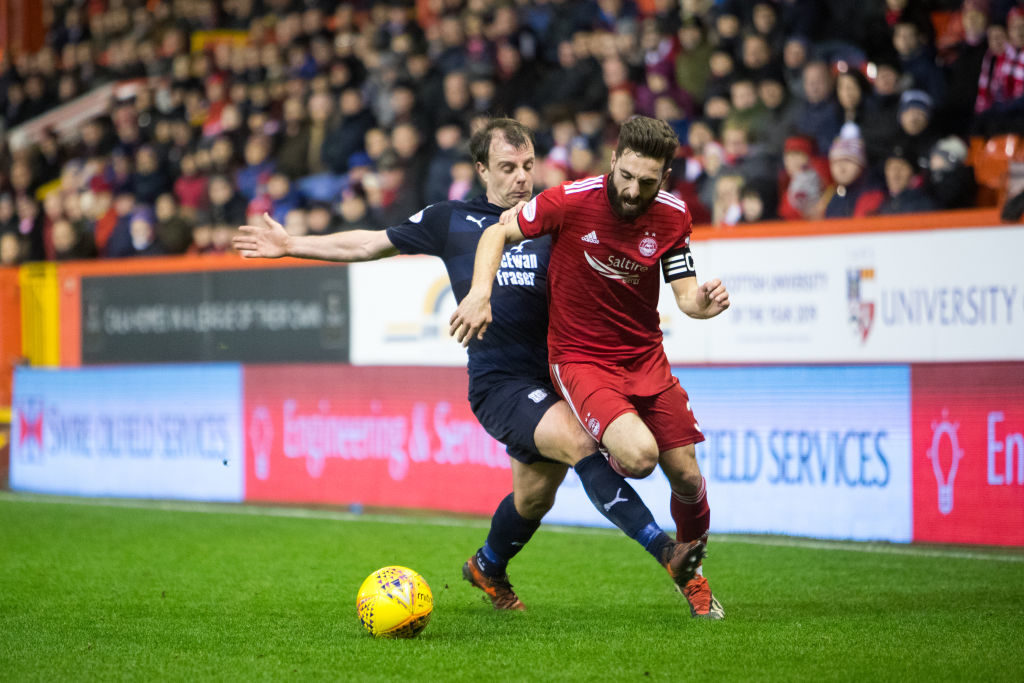 ABERDEEN, SCOTLAND - DECEMBER 18: Paul McGowan of Dundee tackles Graeme Shinnie of Aberdeen during the Ladbrokes Scottish Premiership match between Aberdeen and Dundee at Pittodrie Stadium on December 18, 2018 in Aberdeen, Scotland.