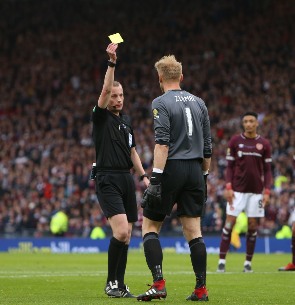 25th May 2019, Hampden Park, Glasgow, Scotland; Scottish Football Cup Final, Heart of Midlothian versus Celtic; Willie Collum shows a yellow card to Zdenek Zlamal of Heart of Midlothian for bringing down Celtic's Odsonne Edouard for a penalty kick