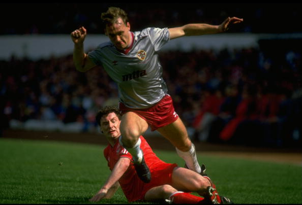 1986: Jim Bett of Aberdeen tackles Sandy Clark (top) of Hearts during the Scottish Cup Final match at Hampden Park in Glasgow, Scotland. Aberdeen won the match 3-0. Mandatory Credit: