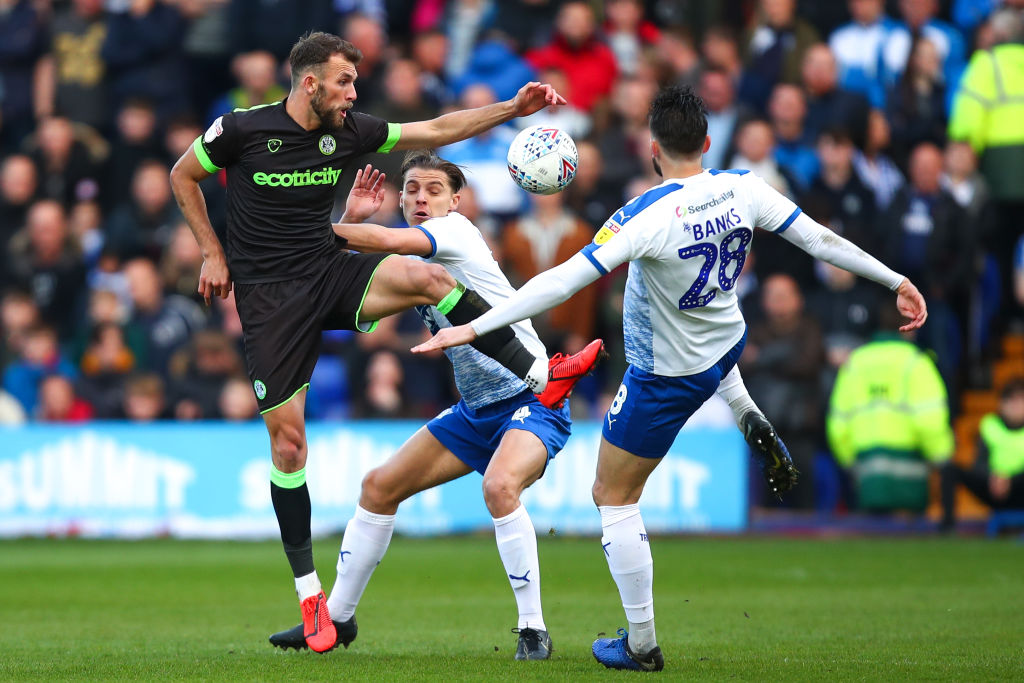 BIRKENHEAD, ENGLAND - MAY 10: Christian Doidge of Forest Green Rovers and Oliver Banks of Tranmere Rovers during the Sky Bet League Two Play-off Semi Final First Leg match between Tranmere Rovers and Forest Green at Prenton Park on May 9, 2019 in Birkenhead, United Kingdom.