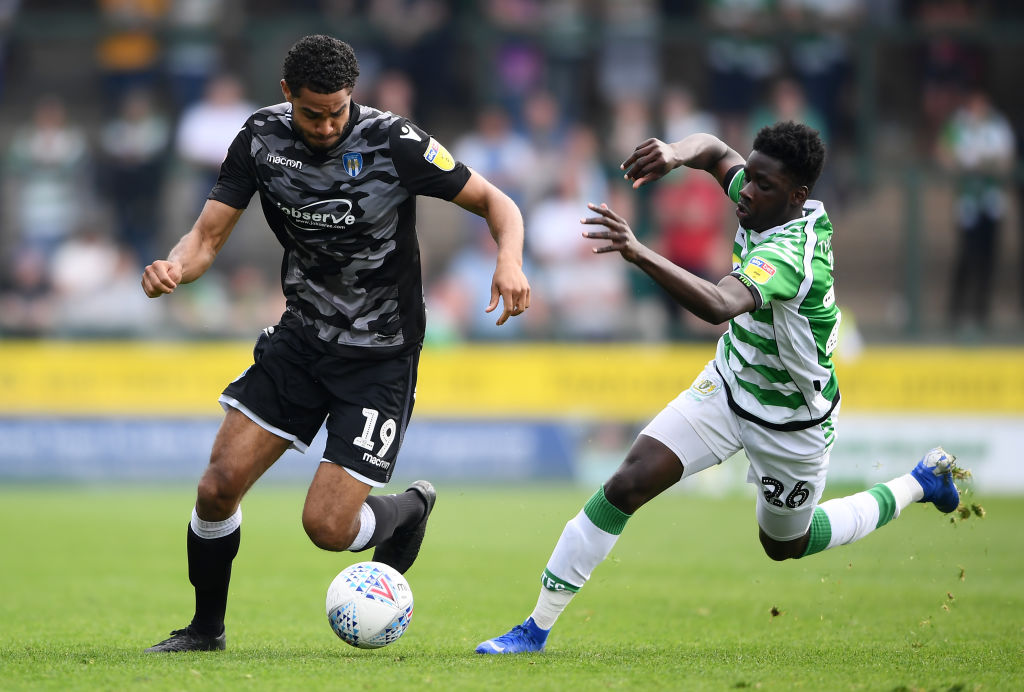 YEOVIL, ENGLAND - APRIL 22: Mikael Mandron of Colchester United gets past Daniel Ojo of Yeovil Town during the Sky Bet League Two match between Yeovil Town and Colchester United at Huish Park on April 22, 2019 in Yeovil, United Kingdom.
