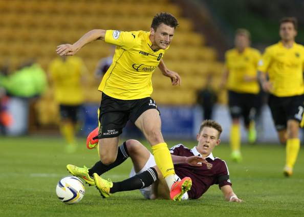 LIVINGSTON, SCOTLAND - AUGUST 20: Michael McKenna of Livingston is tackled by Angus Beith of Hearts during Petrofac Training Cup second round match between Livingston and Hearts at Almondvale Stadium on August 20, 2014 Livingston, Scotland.
