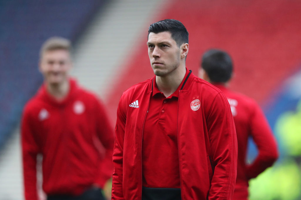 GLASGOW, SCOTLAND - DECEMBER 02: Scott McKenna of Aberdeen walks on the pitch with team mates prior to the Betfred Cup Final between Celtic and Aberdeen at Hampden Park on December 2, 2018 in Glasgow, Scotland.
