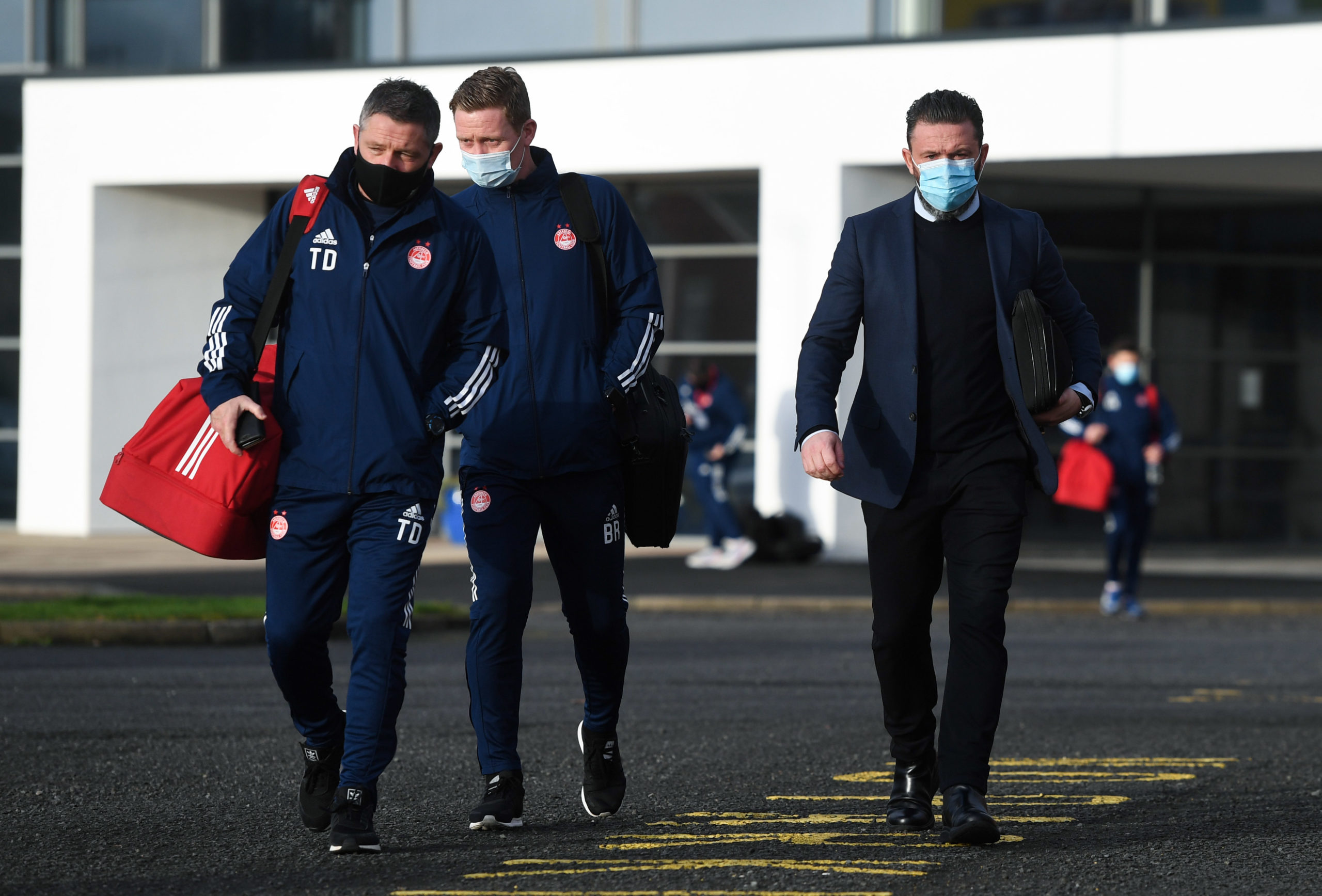 KILMARNOCK, SCOTLAND - DECEMBER 20: Aberdeen manager Derek McInnes (R), Tony Docherty and Barry Ronson arrive ahead of a Scottish Premiership match...