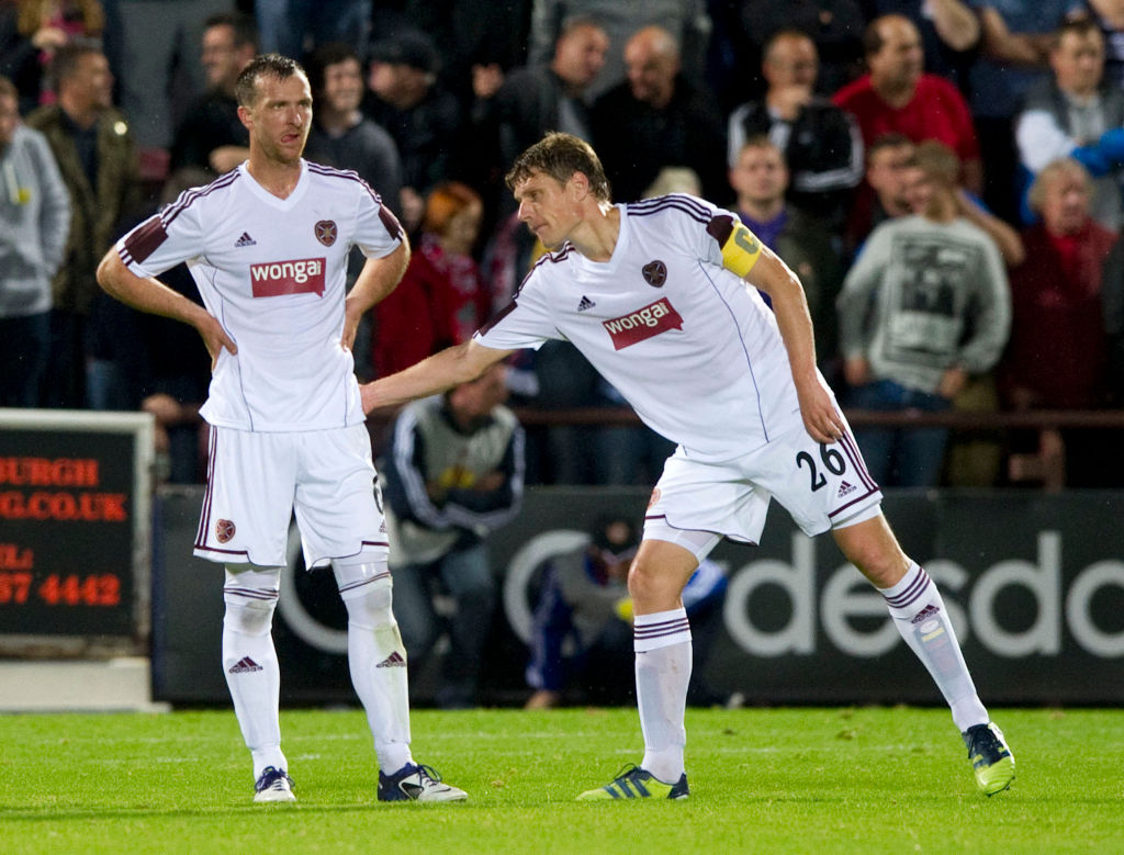 23/08/12 UEFA EUROPA LEAGUE PLAY-OFF 1ST LEG.HEARTS v LIVERPOOL.TYNECASTLE - EDINBURGH.Hearts captain Marius Zaliukas (right) gives encouragement to team-mate Andy Webster after his own goal
