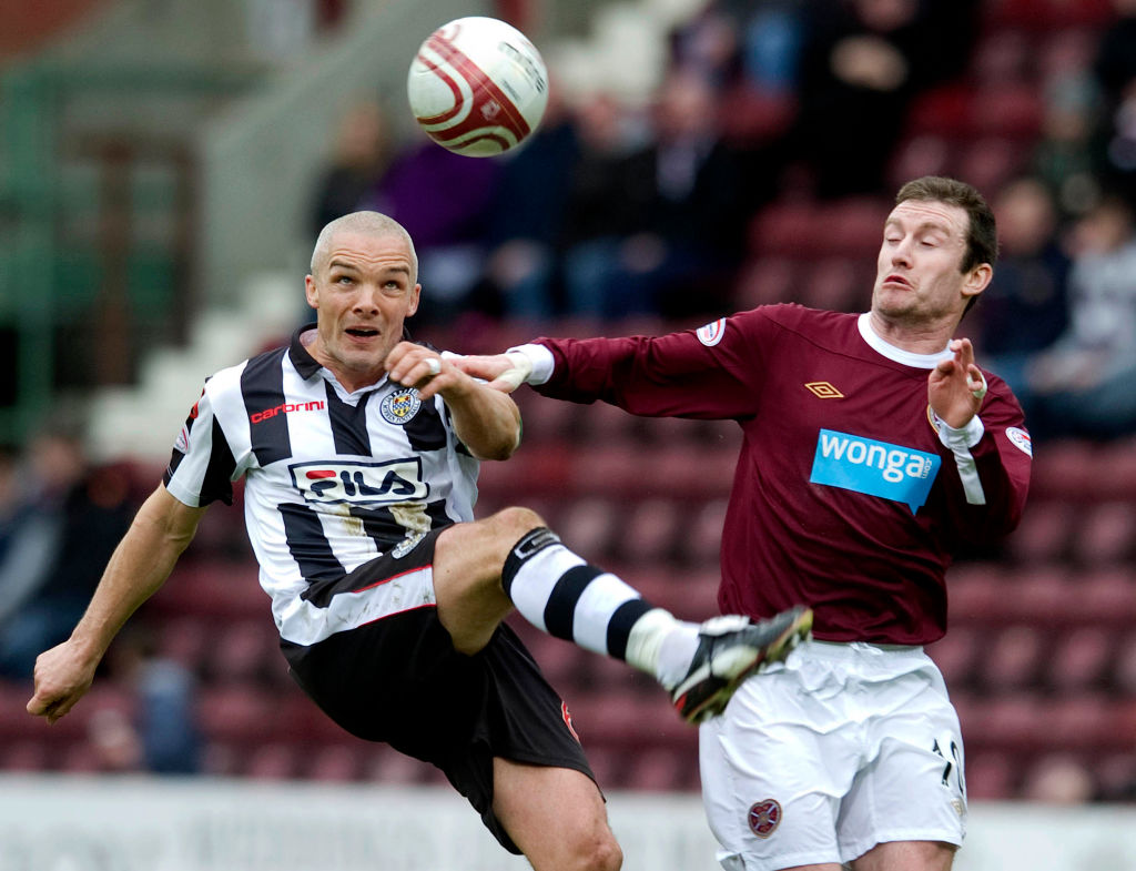 10/03/12 WILLIAM HILL SCOTTISH CUP QUARTER FINAL.HEARTS v ST MIRREN TYNECASTLE - EDINBURGH.Jim Goodwin (left) battles it out with Hearts star Stephen Elliott