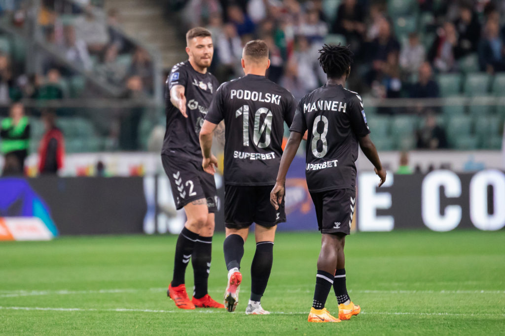 (L-R) Przemyslaw Wisniewski, Lukas Podolski, and Alasana